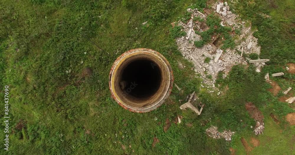 4K aerial summer cloudy day drone video of abandoned dilapidated industrial building ruins with red brick chimney located by small lake and green field in the middle of countryside 4K aerial summer cloudy day drone video of abandoned dilapidated industrial building ruins with red brick chimney located by small lake and green field in the middle of countryside