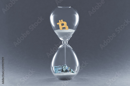 Hourglass on dark background. Concept passing traditional currency time, and time cryptocurrency Bitcoin and blockchain technology.