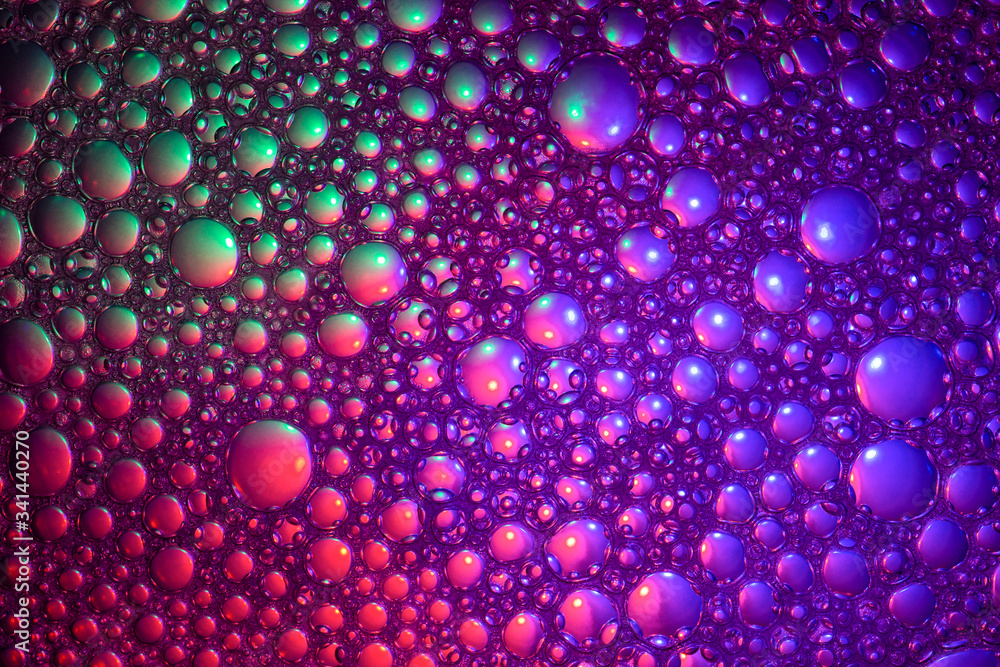 Abstract color background. Bubbles of oil in a colored liquid and lighting in macro photography. Creative and art concept Abstract color background. Bubbles of oil in a colored liquid and lighting in macro photography. Creative and art concept