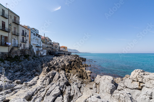 View over the coastline and residential buildings from Bastione di Capo Marchiafava bastion lookout point on a sunny day in Cefalu, Sicily, Italy. photo