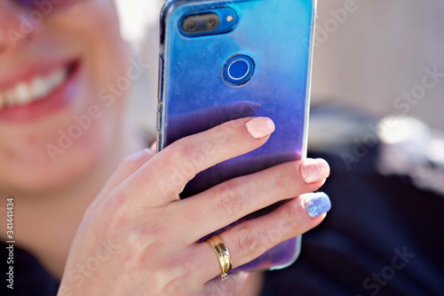 Girl with a hand using mobile Smart Phone