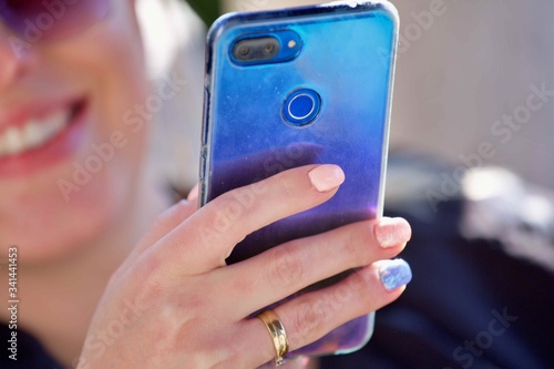 Girl with a hand using mobile Smart Phone
