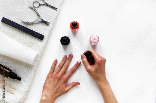 Do female manicure by yourself while staying at home during quarantine, staying safe. top view, flat lay, copy space. Step by step instruction. Step 1 Apply base coat photo