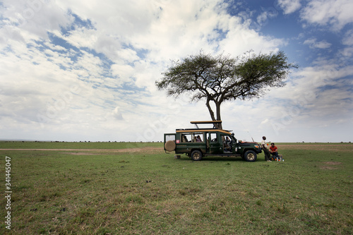 Tourists enjoying food in the mid of game drive in Masai Mara National Reserve