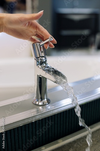 hand close water tap. Open chrome faucet washbasin