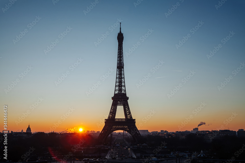 Eiffel tower silhouette against the backdrop of the rising sun. Beautiful sunrise over Paris