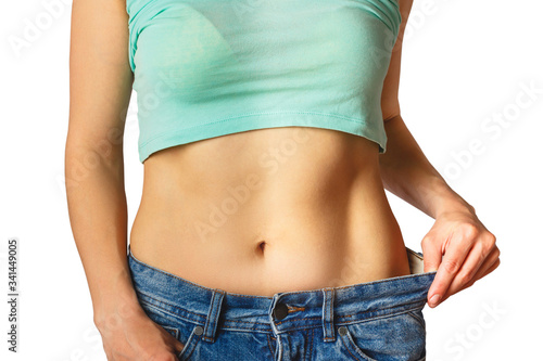 Slim beautiful woman wears jeans large size, diet concept