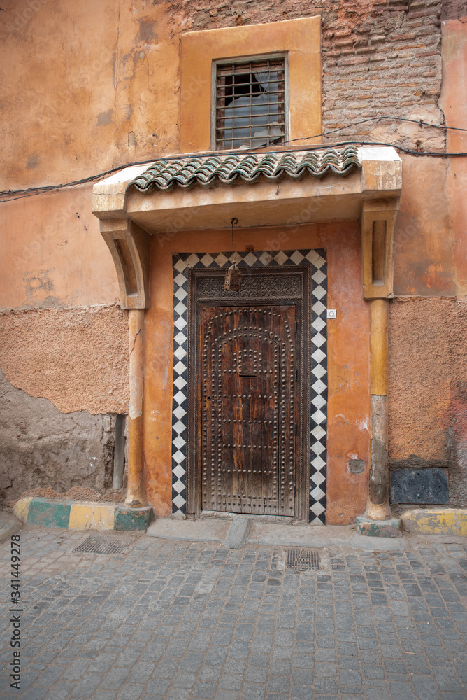 Old carved wooden door with decorative studs, Marrakech, Morocco Old carved wooden door with decorative studs, Marrakech, Morocco