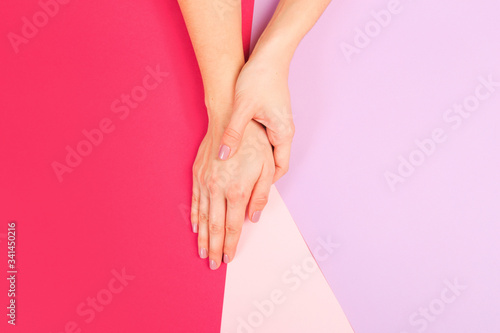 female  manicure. Beautiful young woman s hands on color pink  background - Image