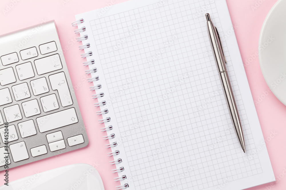 Pink workplace with computer, notepad and coffee Pink workplace with computer, notepad and coffee