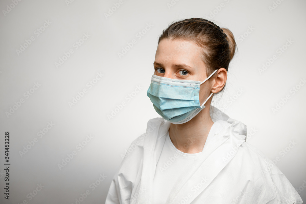 Young female doctor wearing protective suit and medical mask. Young female doctor wearing protective suit and medical mask.