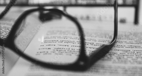 glasses on the book black and white