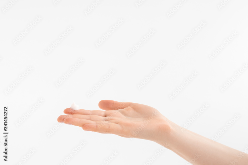 Daily skincare, mosturizing lotion on her hand. Beautiful lady's hand with cream on grey background. Palm facing up. Daily skincare, mosturizing lotion on her hand. Beautiful lady's hand with cream on grey background. Palm facing up.
