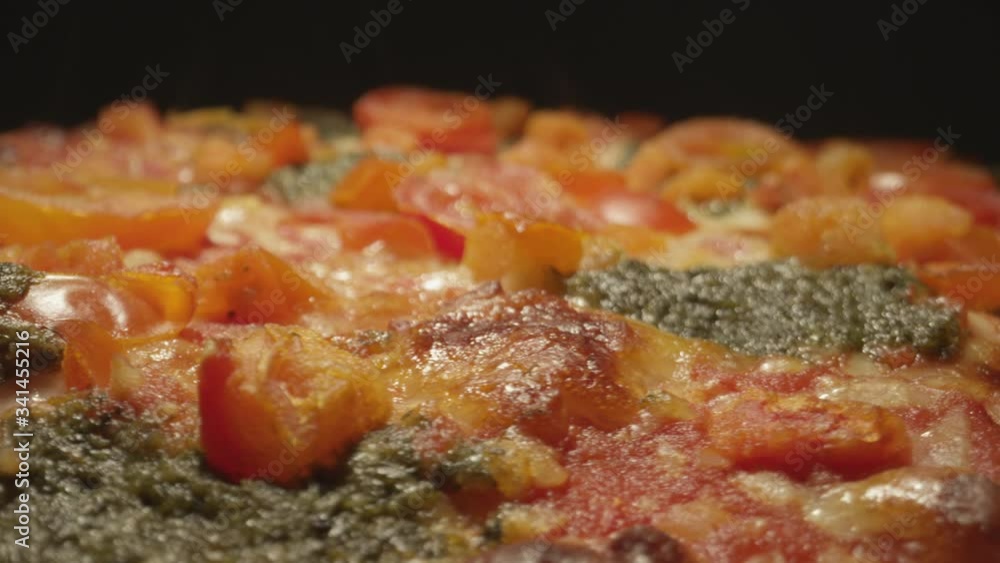 Close up macro of a gourmet pizza fresh out of the oven in a restaurant kitchen Close up macro of a gourmet pizza fresh out of the oven in a restaurant kitchen