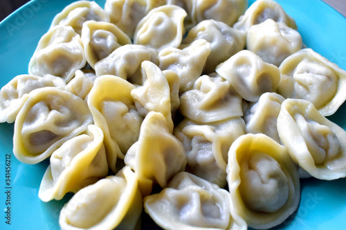 White dumplings with meat on a blue plate