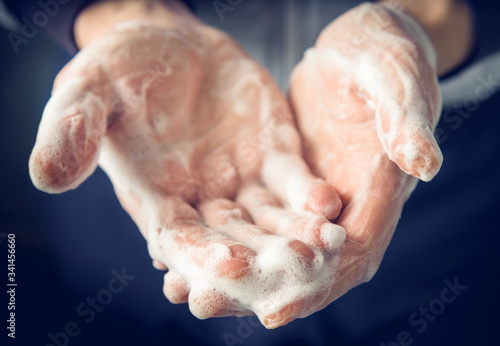 Man's hands washed with soap and foam, close up.