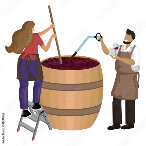Male winemaker checks wine during fermentation process and female winemaker mixes and shakes grape pulp in large wooden vat