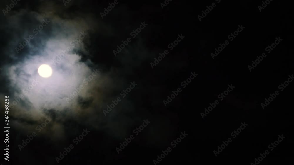 Night sky. Mystery clouds moves through the full moon. Occultism rituals. Creepy atmosphere Night sky. Mystery clouds moves through the full moon. Occultism rituals. Creepy atmosphere