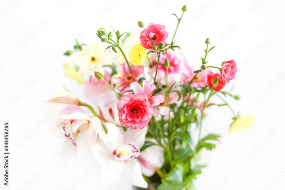 Beautiful fresh spring bouquet of flowers with ranunculus on white isolated background. Perfect postcard for mother's day, international women's day.