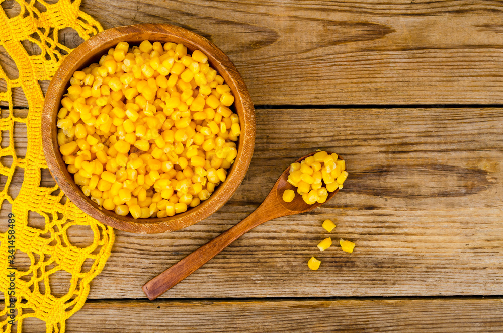 Sweet ripe canned corn in wooden bowl. Sweet ripe canned corn in wooden bowl.