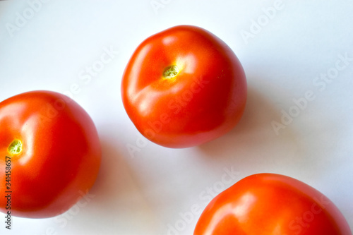 Red and juicy tomatoes on a white background