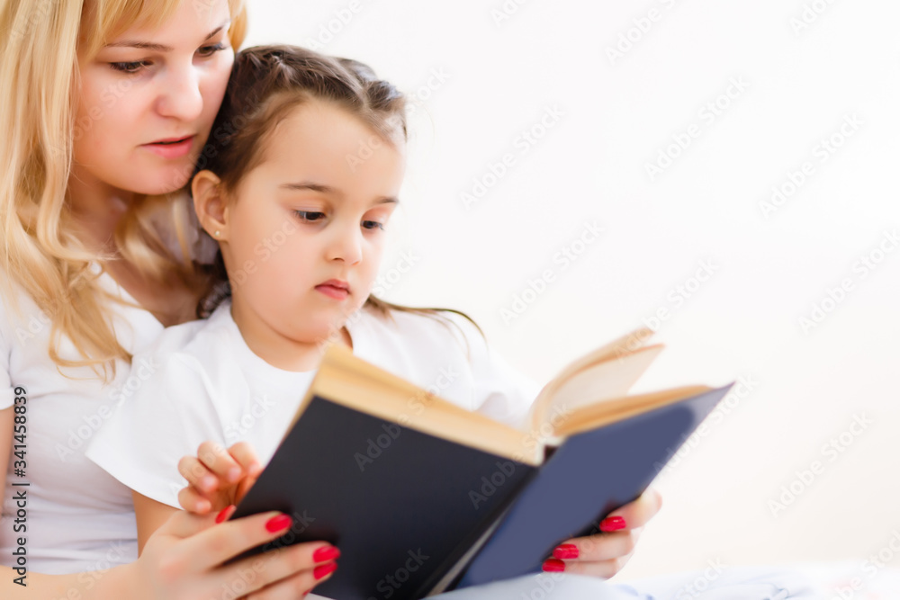 Mother And Daughter Reading Story At Home Together Mother And Daughter Reading Story At Home Together