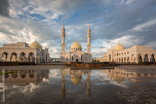 Beautiful white mosque in Bolgar reflected in the water against the backdrop of a beautiful sky 