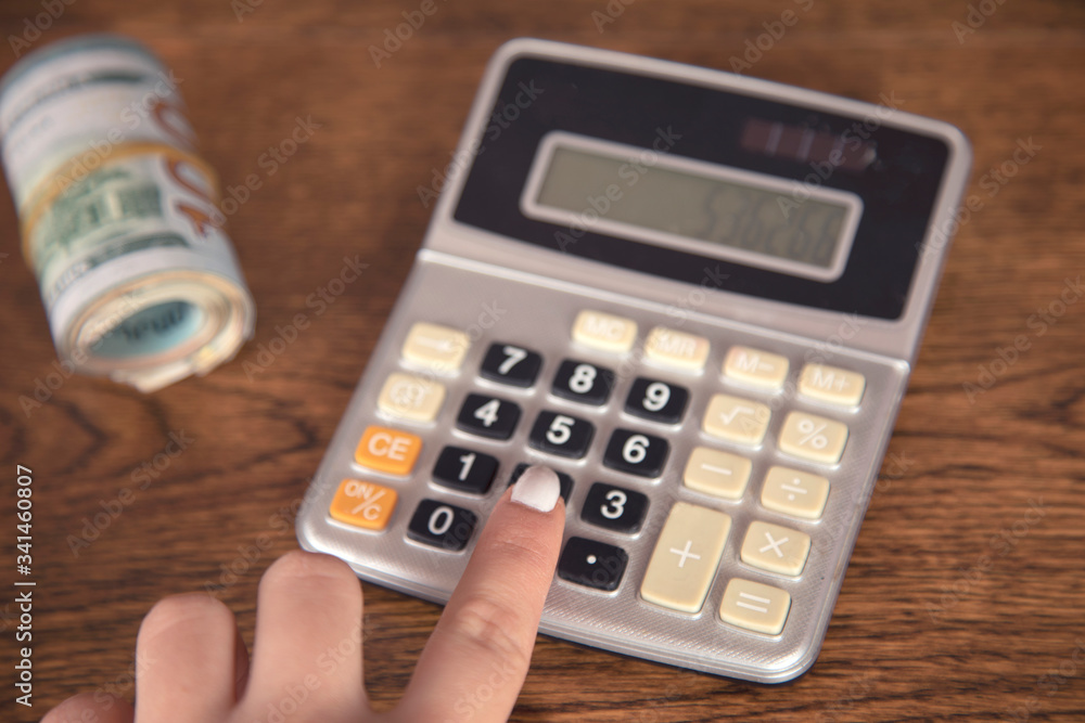 woman hand calculator and dollar woman hand calculator and dollar