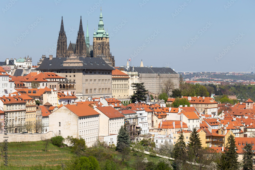 Naklejka premium Spring Prague City with gothic Castle and the green Nature and flowering Trees from the Hill Petrin, Czech Republic