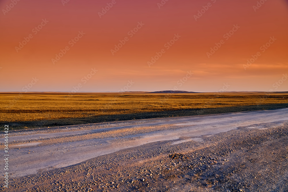 Panoramic view: beautiful spring landscape: spring huge great steppe wakes up from winter sleep - snow and ice just melted, sunset, Kazakhstan Panoramic view: beautiful spring landscape: spring huge great steppe wakes up from winter sleep - snow and ice just melted, sunset, Kazakhstan