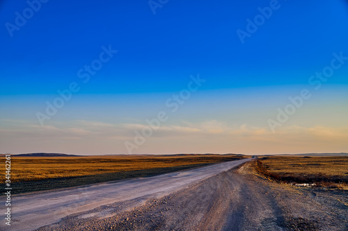 Panoramic view  beautiful spring landscape  spring huge great steppe wakes up from winter sleep - snow and ice just melted  sunset  Kazakhstan