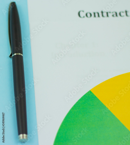 Business contract and pen close-up on a blue background