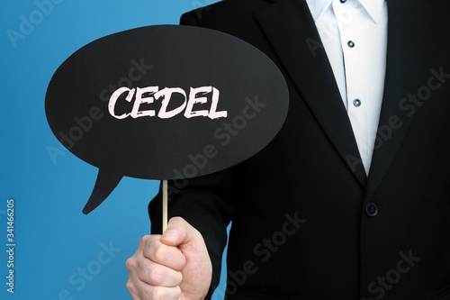 CEDEL. Geschäftsmann im Anzug hält Sprechblase in die Kamera. Der Begriff CEDEL steht im Schild. Symbol für Business, Finanzen, Statistik, Analyse, Wirtschaft photo