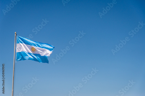Argentinian flag waving against blue sky on a sunny day 