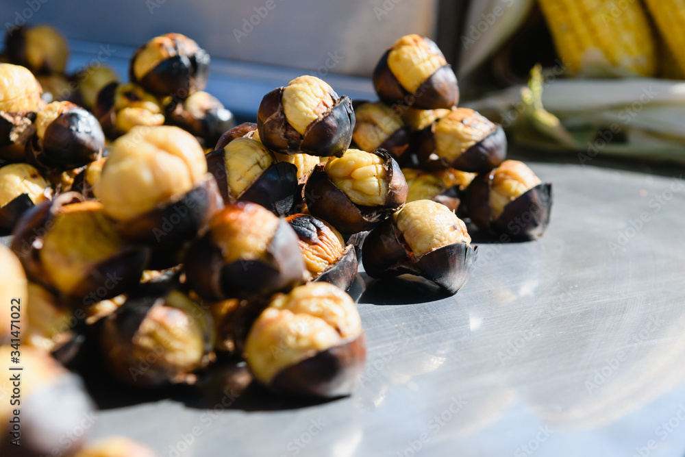 Roasted chestnuts at street food market outdoors Roasted chestnuts at street food market outdoors