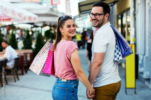 Young couple in shopping. Consumerism, love, dating, lifestyle concept