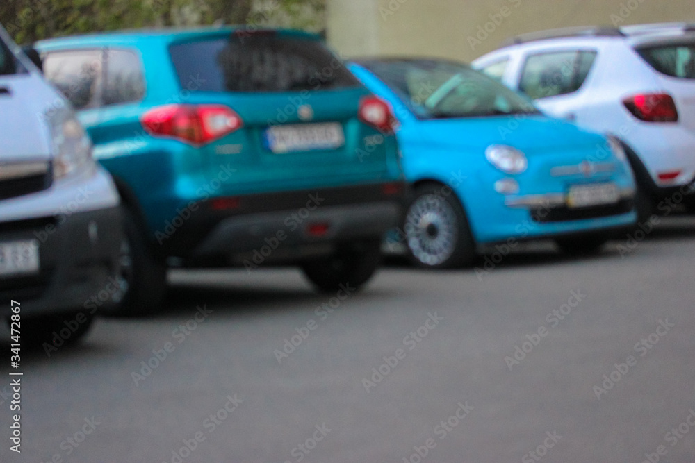 Blurred cars of different brands in the parking lot