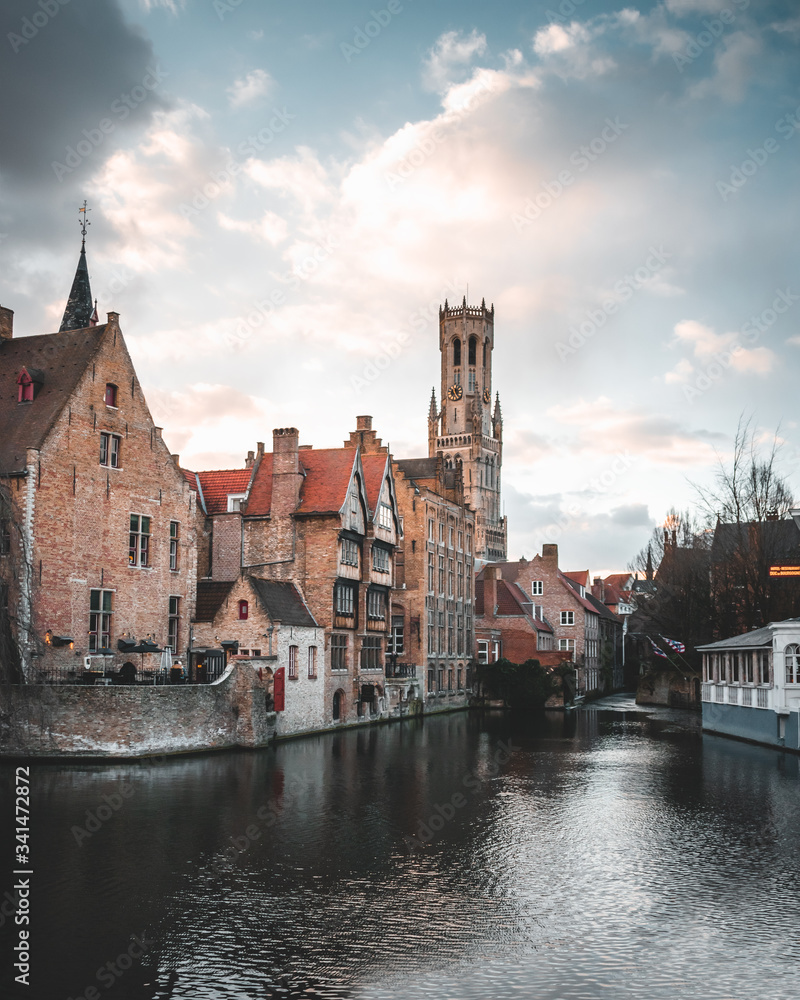 Bruges / Belgium - February 17 2018: Beautiful European medieval historic city Bruges during a golden sunset, sightseeing historical buildings Belfry