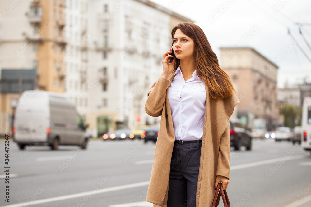 Young beautiful woman with a mobile phone