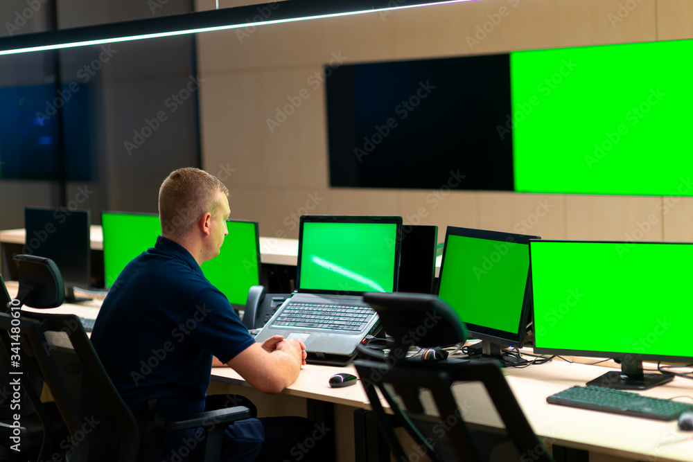Male operator watching the cctv monitors