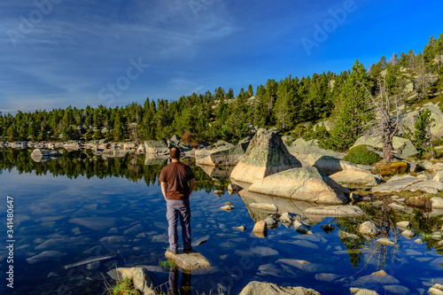 Hiker relaxing at the lake in the mountains. photo