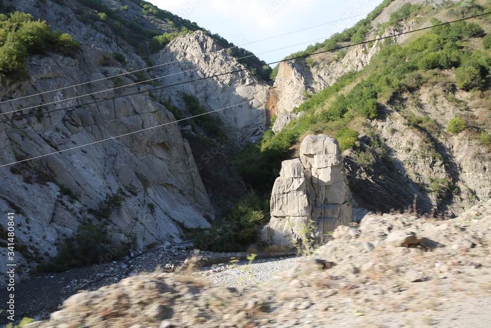 Mountainous road leading to Lahic village in Ismayilli region of Azerbaijan, with car.