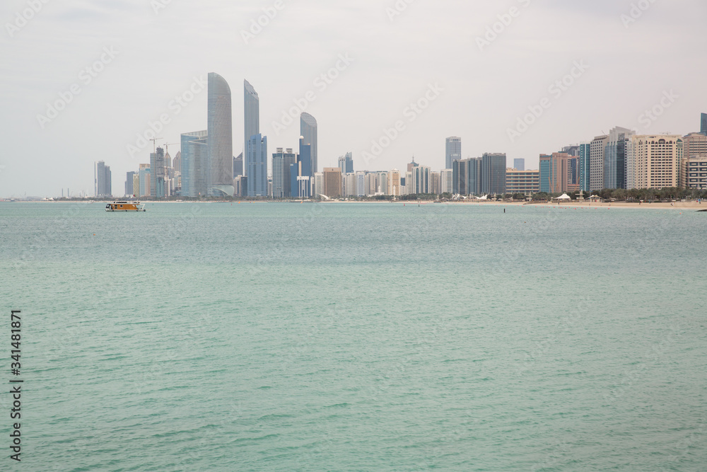 on the beach against the backdrop of Abu Dhabi buildings