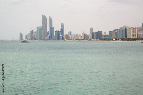 on the beach against the backdrop of Abu Dhabi buildings