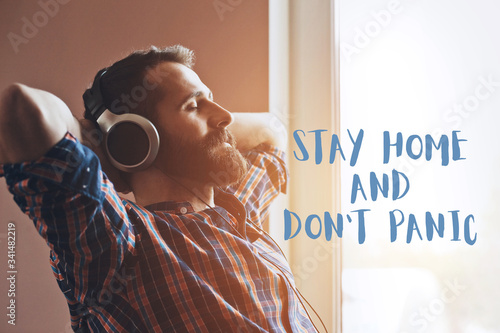 handsome bearded man  in headphones listening to music photo