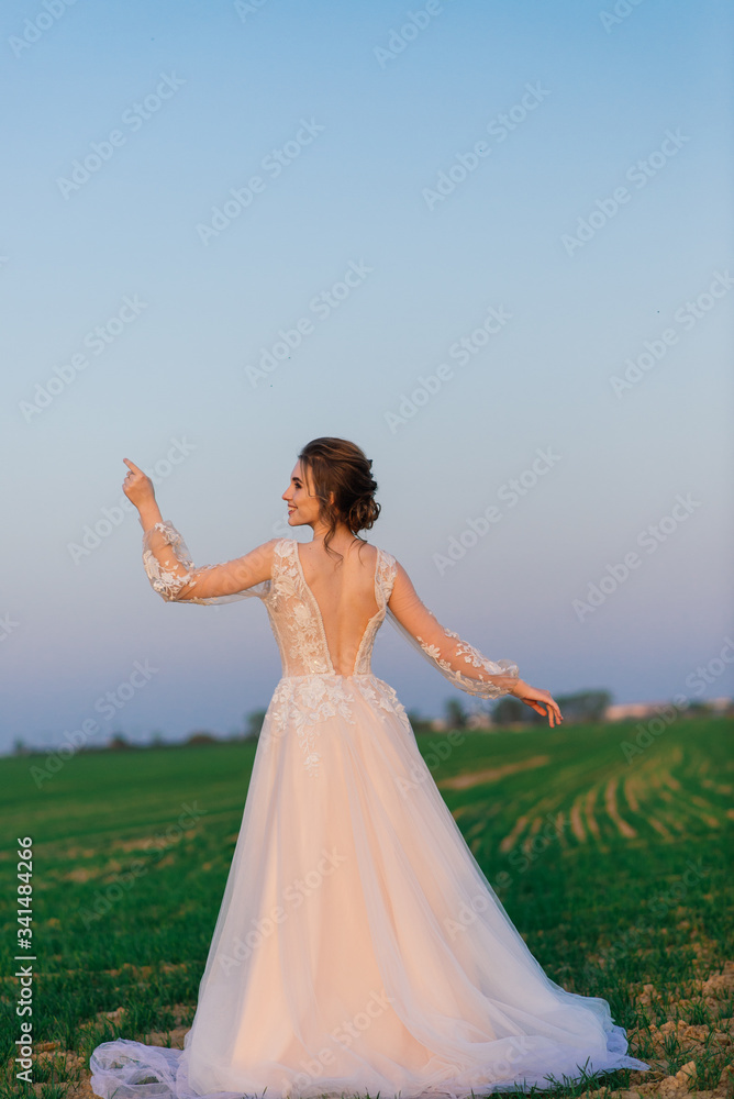 Young beautiful woman in blooming garden. Bride.