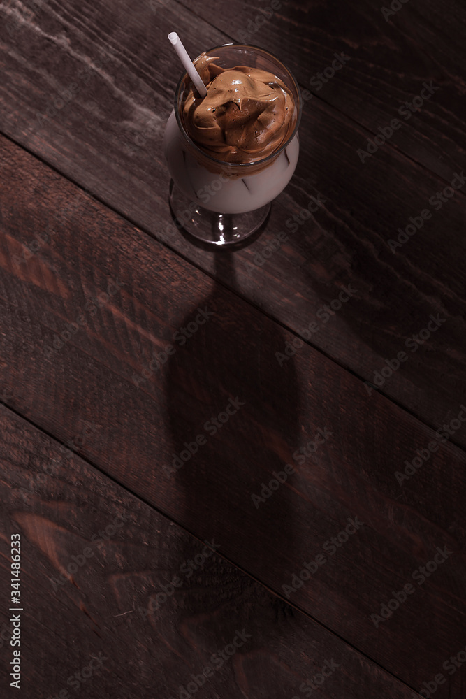 Cold trendy drink Korean dalgon iced coffee on a dark background. delicious and popular coffee in the trend Cold trendy drink Korean dalgon iced coffee on a dark background. delicious and popular coffee in the trend