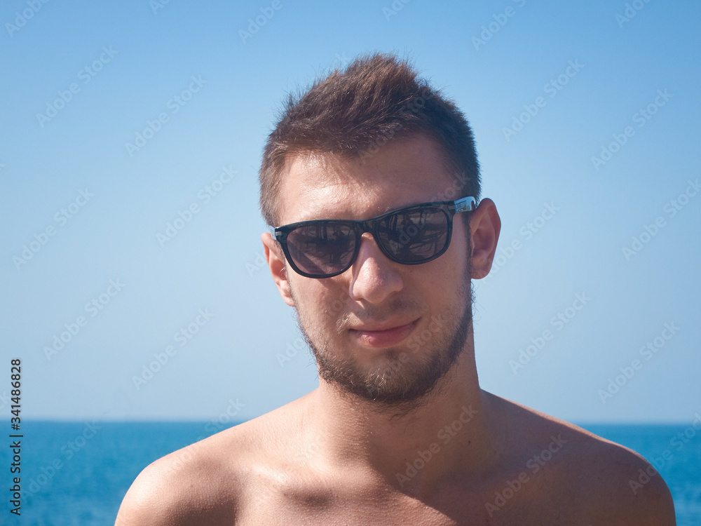 portrait of a young man in sunglasses portrait of a young man in sunglasses