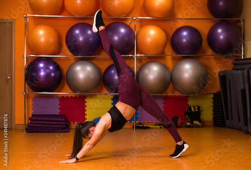 Young woman practicing yoga in a fitness gym