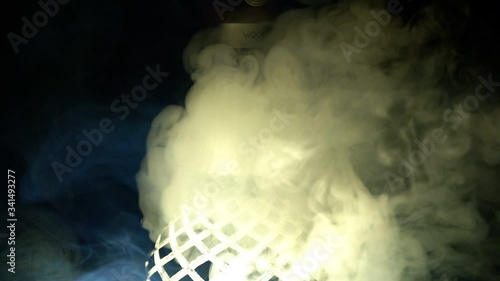 A close-up of the hookah finds thick light smoke on a black background, slow motion photo